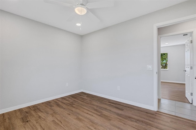 empty room featuring ceiling fan and wood-type flooring