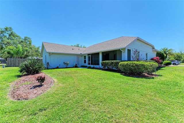 back of house featuring a lawn