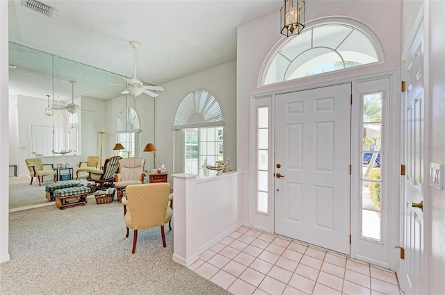 entryway with ceiling fan and light tile patterned flooring