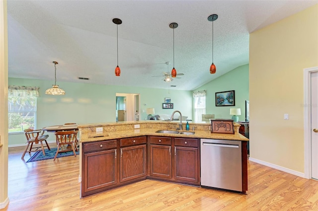 kitchen featuring dishwasher, a center island with sink, lofted ceiling, and sink