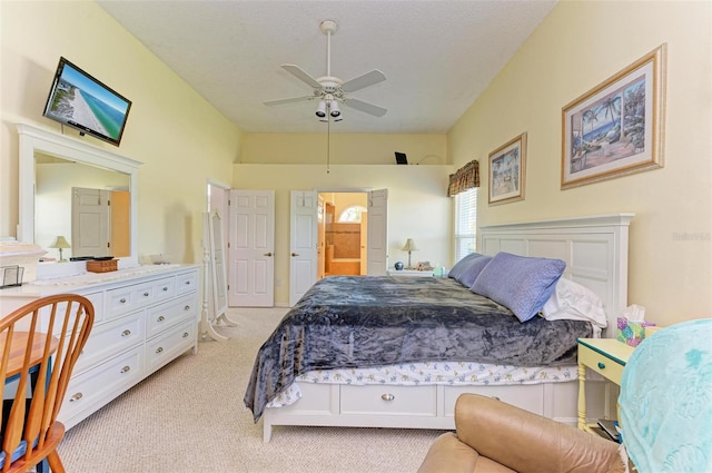 carpeted bedroom featuring ceiling fan and ensuite bathroom