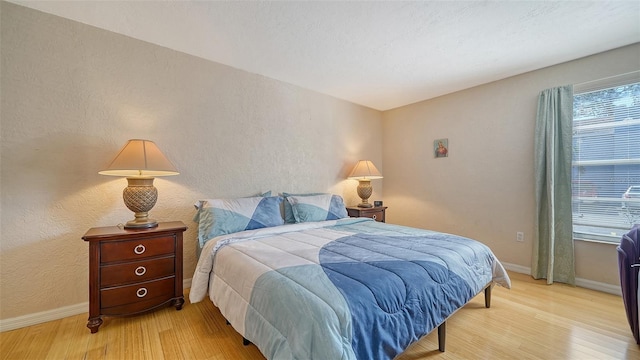 3609 59th Ave W Unit 4045, Bradenton, FL 34210 - bedroom featuring light wood-type flooring, baseboards, and a textured wall