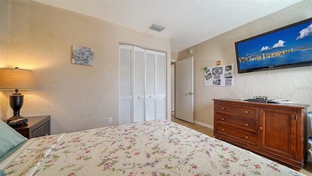 bedroom with light wood-type flooring and a closet