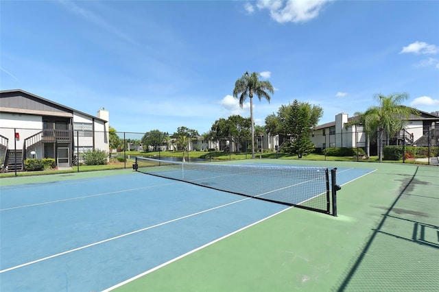 view of tennis court featuring basketball court