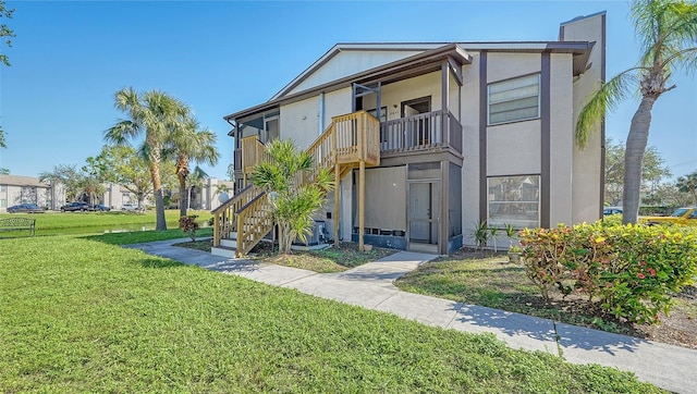 3609 59th Ave W Unit 4045, Bradenton, FL 34210 - view of front facade featuring a balcony, a front yard, and stairway