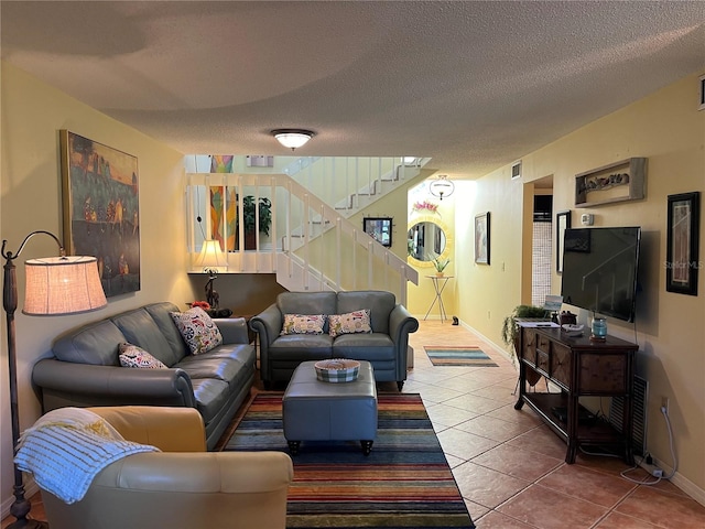 living room with tile patterned floors and a textured ceiling