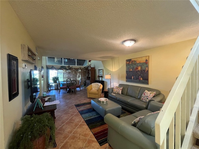 living room with tile patterned floors and a textured ceiling