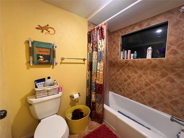 bathroom featuring shower / tub combo and toilet