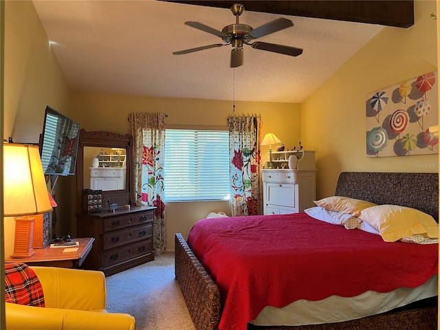 carpeted bedroom with vaulted ceiling with beams, ceiling fan, and a textured ceiling