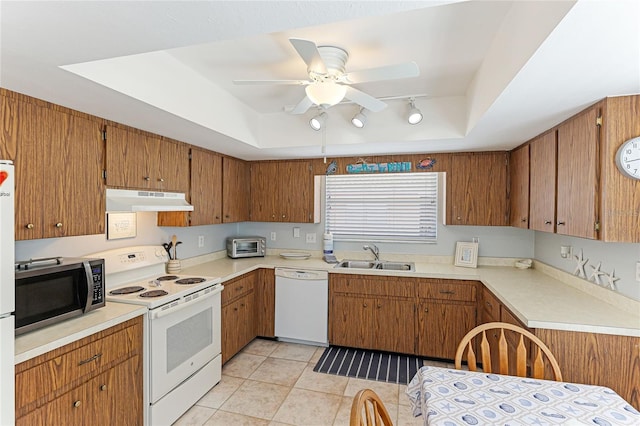 kitchen featuring ceiling fan, sink, white appliances, a tray ceiling, and light tile patterned flooring