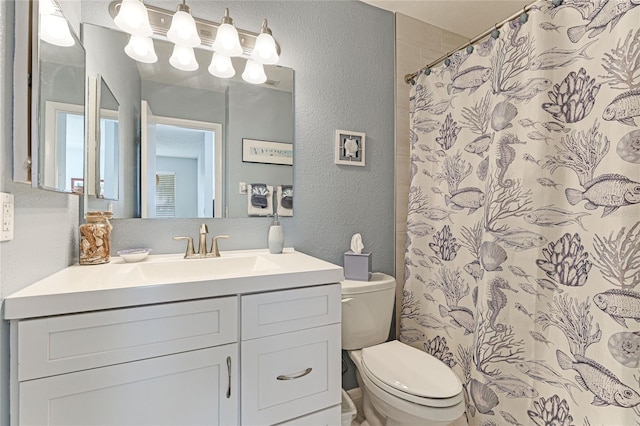 bathroom featuring vanity, toilet, and curtained shower