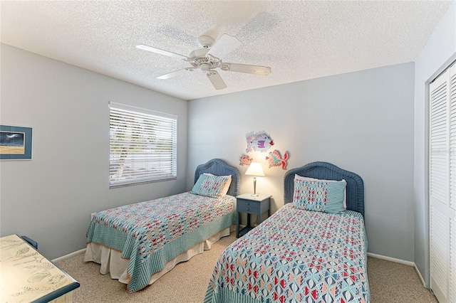 carpeted bedroom with a textured ceiling, a closet, and ceiling fan