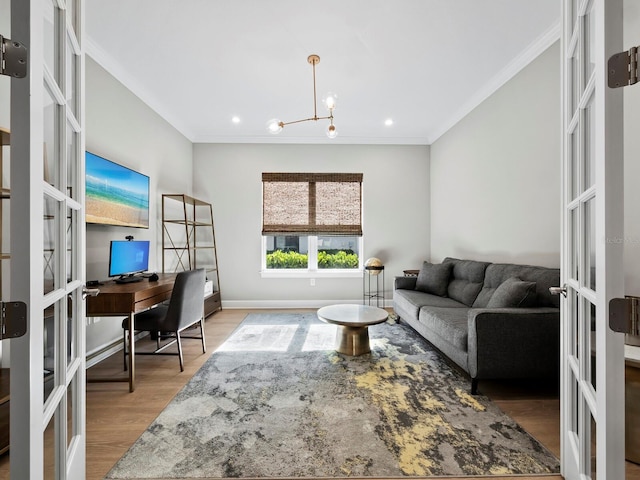 living room featuring french doors, light hardwood / wood-style floors, crown molding, and a notable chandelier