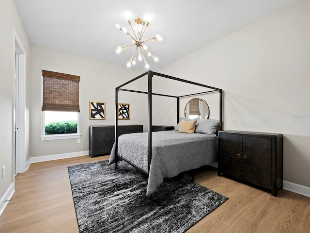 bedroom featuring wood-type flooring and an inviting chandelier