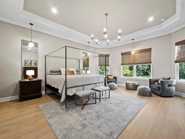 bedroom featuring a raised ceiling, light hardwood / wood-style flooring, and ornamental molding