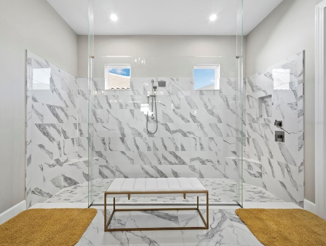 bathroom featuring a tile shower and plenty of natural light