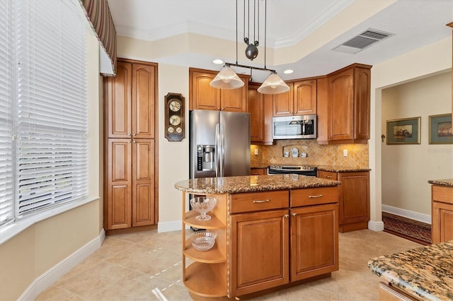 kitchen with appliances with stainless steel finishes, ornamental molding, light tile patterned floors, pendant lighting, and a center island