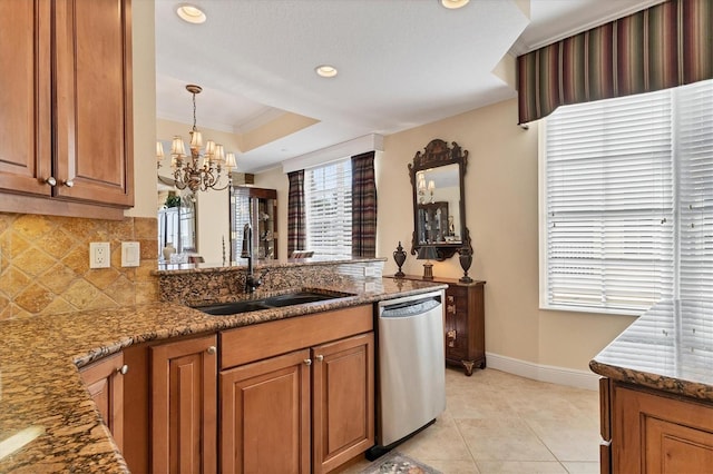 kitchen featuring ornamental molding, sink, a notable chandelier, dark stone countertops, and dishwasher