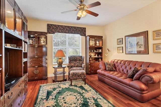 living room with ceiling fan and dark hardwood / wood-style flooring