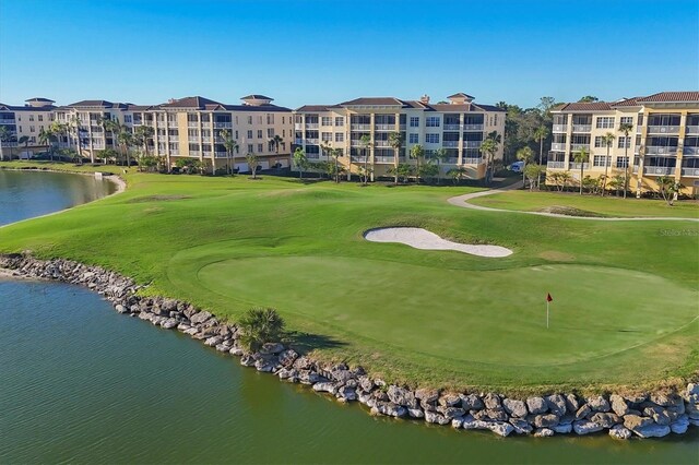 view of community with a yard and a water view