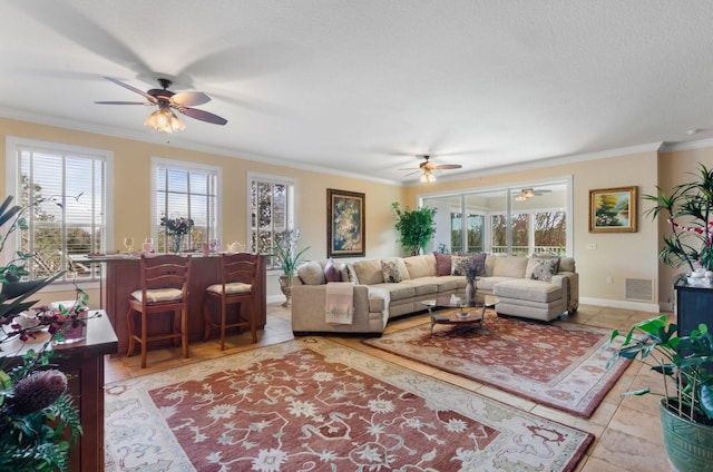 tiled living room with crown molding, ceiling fan, and a textured ceiling