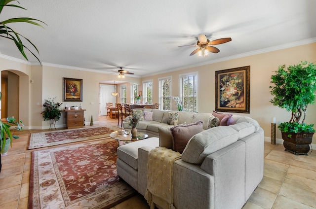 living room with ceiling fan and ornamental molding