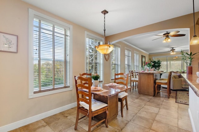 5209 Manorwood Dr Unit 3A, Sarasota, FL 34235 - dining room featuring a ceiling fan, baseboards, arched walkways, and ornamental molding