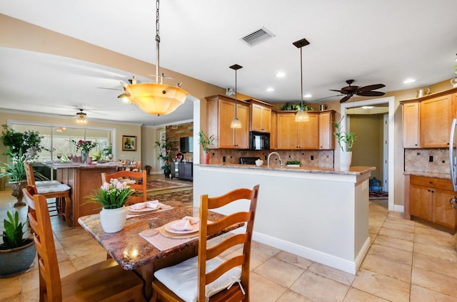 dining room with ceiling fan and light tile patterned floors