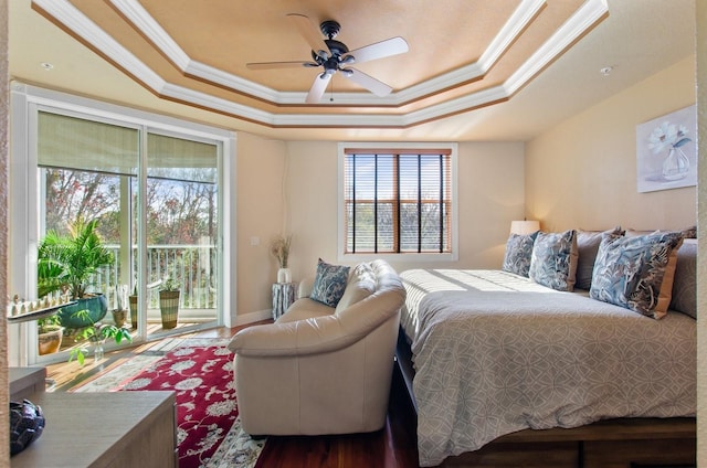 bedroom featuring access to outside, ceiling fan, ornamental molding, and a tray ceiling