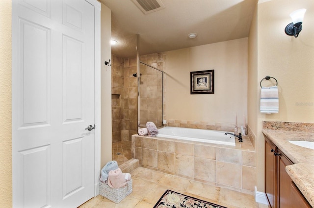 bathroom featuring vanity, a textured ceiling, and shower with separate bathtub