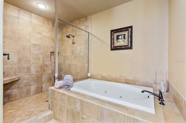 bathroom with shower with separate bathtub and a textured ceiling