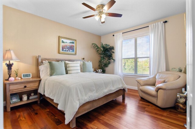 bedroom with ceiling fan and dark wood-type flooring