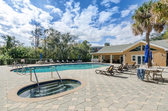 view of swimming pool featuring a patio area and a community hot tub