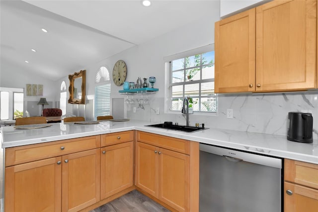 kitchen with lofted ceiling, stainless steel dishwasher, a healthy amount of sunlight, and sink