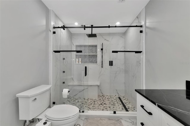 bathroom with an enclosed shower and toilet