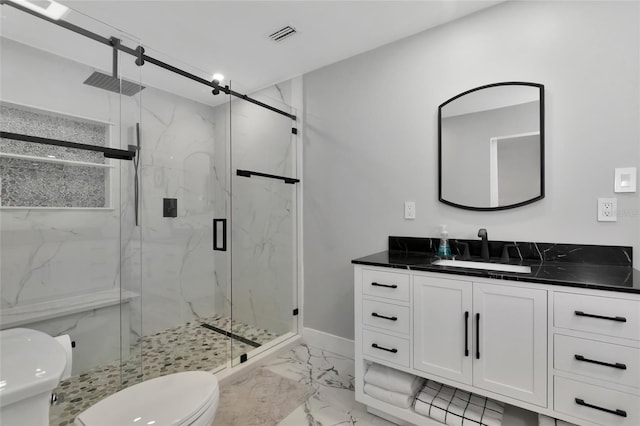 bathroom with an enclosed shower, vanity, and toilet