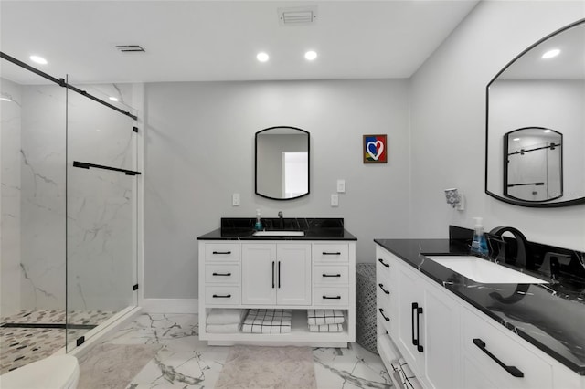 bathroom featuring vanity, toilet, and walk in shower