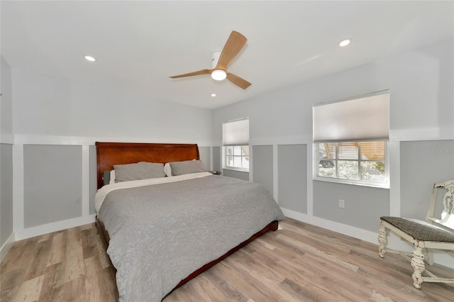 bedroom with ceiling fan and light hardwood / wood-style flooring