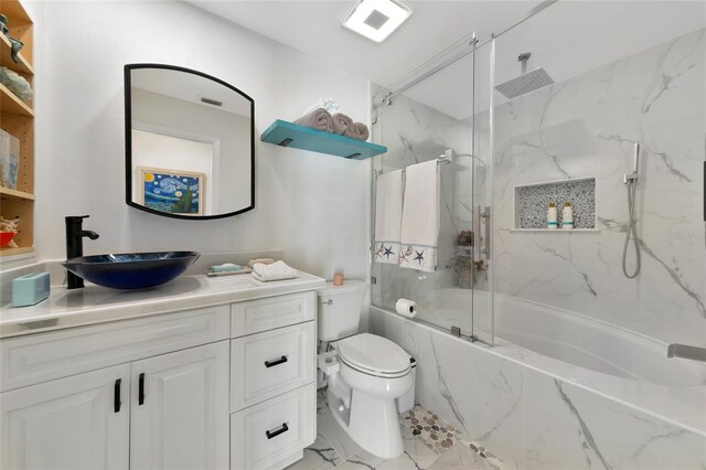 full bathroom with vanity, toilet, and tiled shower / bath