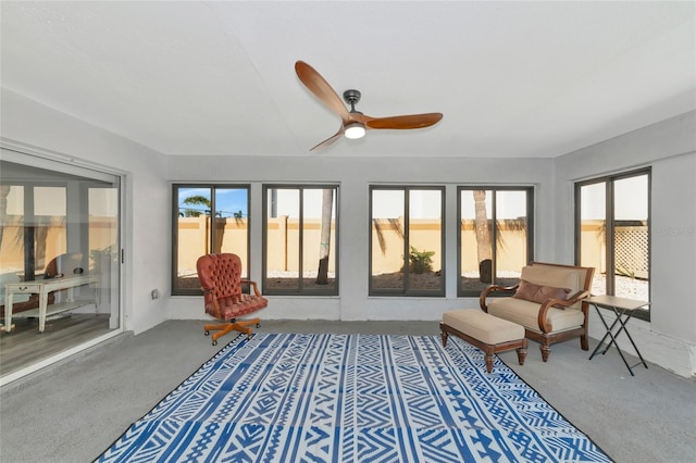 sunroom / solarium featuring ceiling fan