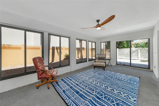 sunroom / solarium featuring ceiling fan