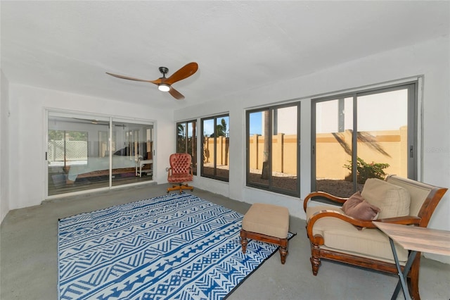 sunroom featuring ceiling fan