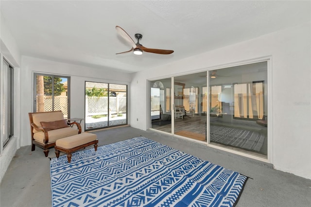 sunroom / solarium featuring ceiling fan