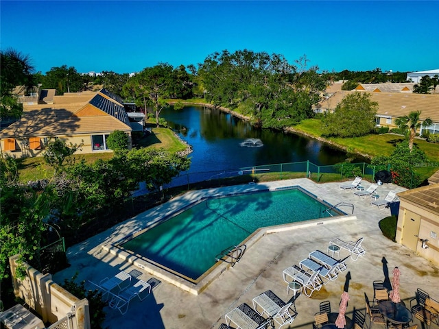 view of swimming pool featuring a water view