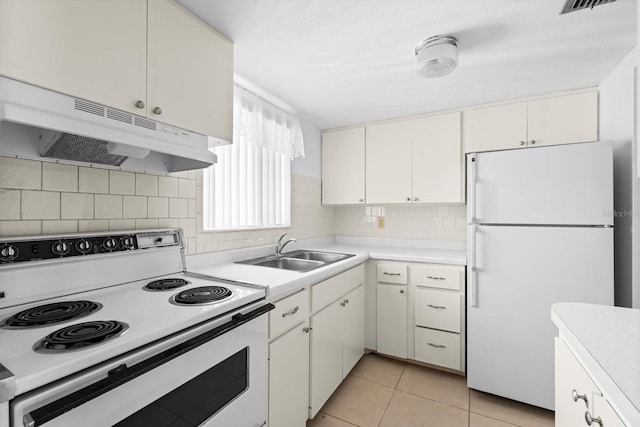 kitchen featuring sink, white cabinets, light tile patterned flooring, and white appliances