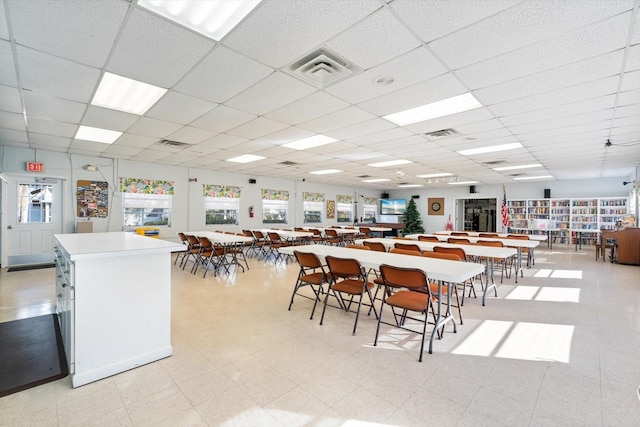 dining space with a paneled ceiling