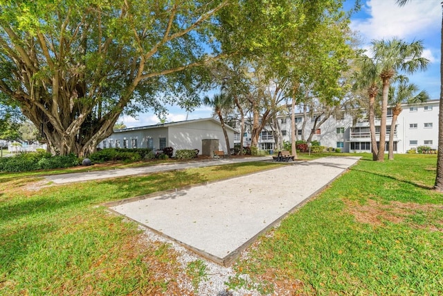 view of property's community with a yard