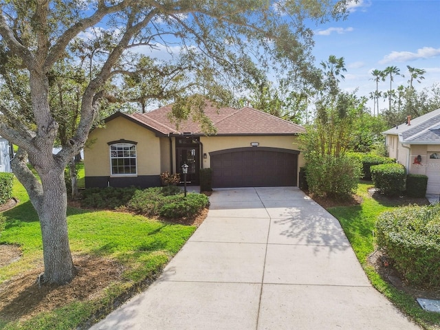 ranch-style house with a garage and a front yard