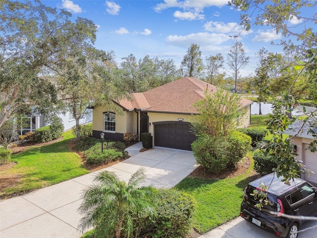 view of front of property featuring a front yard and a garage