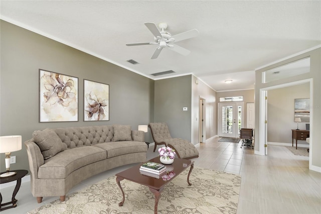 living room featuring ceiling fan, light wood-type flooring, crown molding, and french doors